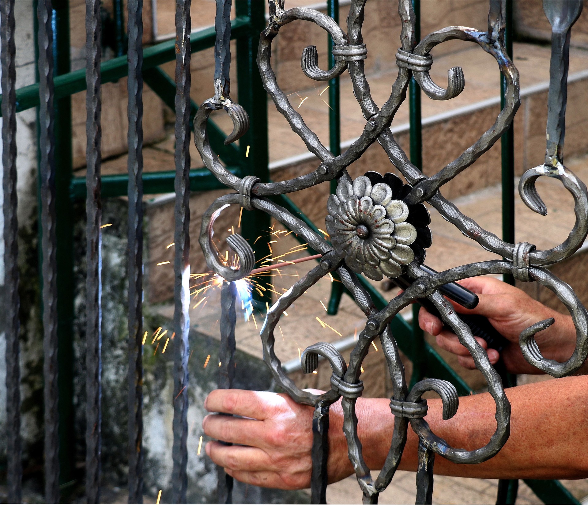 Welder at work, welding metal gate